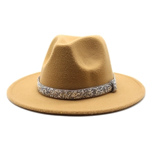 Detail of camel wool fedora hat featuring a sparkling rhinestone decorative band