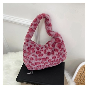 Pink plush crescent bag with leopard animal pattern on white faux fur carpet