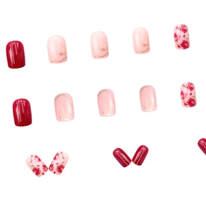 Rose red gradient French manicures with gold edges and floral pattern on white background