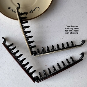 Detail view of double-row anti-slip teeth on a leopard print banana hair clip