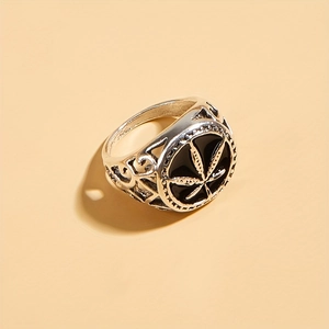 Vintage silver hollow ring featuring a black maple leaf emblem on a minimalist background