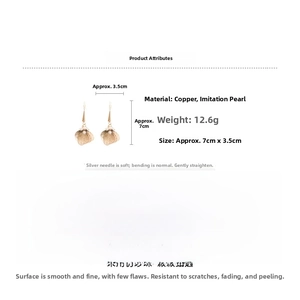 Detailed view of gold petal earrings with pearls, 7cm drop length and 12.6g weight