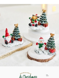 Close-up of miniature resin Christmas figurines with dwarf, elk, and snowman on snow