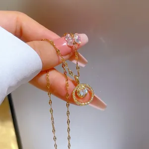 Detailed macro view of gold-plated double ring necklace with zircon inlay