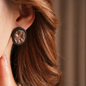 Irregular geometric stud earrings with retro industrial black matte edges and textured center