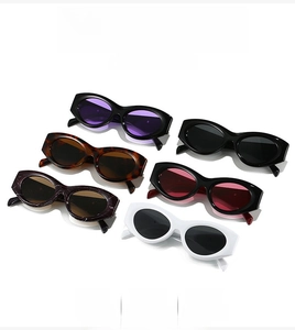Detail view of oval cat-eye sunglasses collection in black, white, and tortoiseshell frames