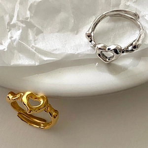 Detailed macro view of S925 sterling silver heart rings with lava texture and S925 stamp