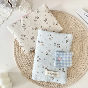 Close-up of floral fabric covers with corduroy texture and vintage heart embroidery