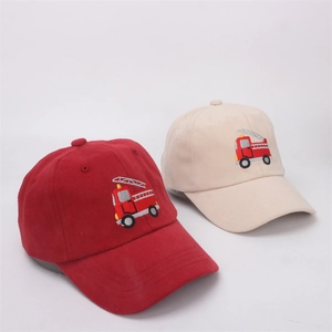Detail of embroidered fire truck pattern on cotton baseball caps in red and beige