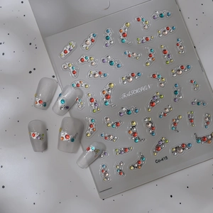 Macro view of Co-415 rhinestone nail stickers with silver frames and colored gems