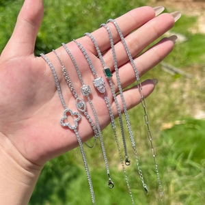 Detailed collection of silver tennis bracelets with clover and eye motifs in natural light