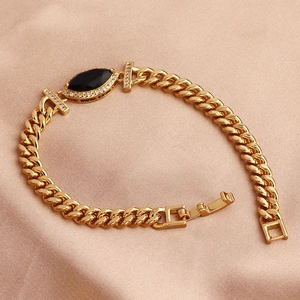 Close-up of gold plated bracelet with black marquise stone and zircon accents