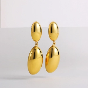 Close-up of minimalist 18K gold double oval drop earrings with a polished mirror finish