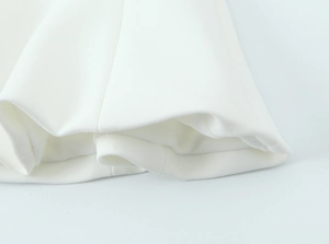 Detailed macro view of pure white woven fabric texture and high-quality hem stitching