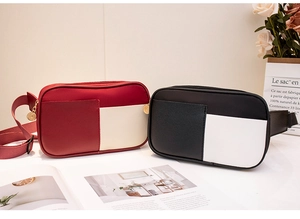 Detail of color-block chest bags in red-beige and black-white with gold zippers