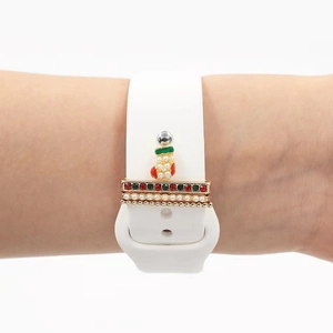 Detail of white silicone watch band featuring Christmas sock and gemstone charms