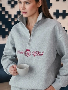 Detail of red Moda Club embroidery on gray fleece sweatshirt with half-zip collar design