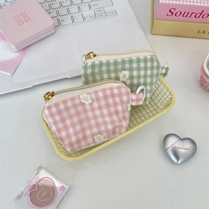 Floral embroidery checkerboard makeup pouches in pink and green with gold zipper detail