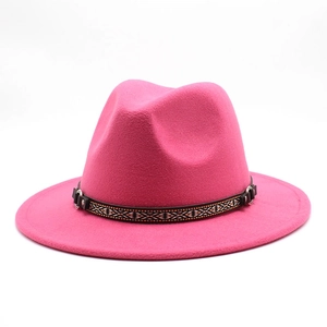 Detail of fuchsia wool fedora hat with bohemian woven band and metal ring accent