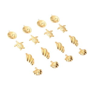 Set of 15 golden stainless steel ocean charms featuring shell, turtle, and conch designs