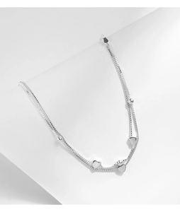 Detail view of double-layer S925 silver bracelet featuring polished heart charms and beads