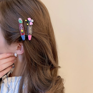 Side view of trendy colorful acrylic star hair clips on model for hair styling