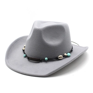 Close-up of a gray wool cowboy hat featuring an ethnic band with turquoise and shell detail
