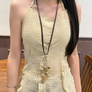 Bohemian ivory necklace with multiple alloy and wooden charms shown on a model
