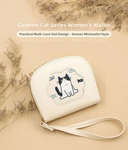 Detail of cream-colored PU leather cat wallet with embroidery and secure wrist strap