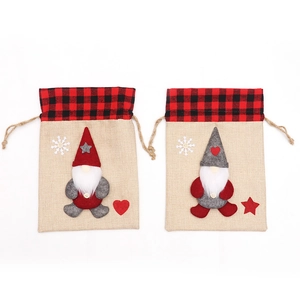 Set of two Christmas burlap gift bags with gnome design and red plaid drawstring closure