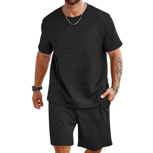Detail of black waffle knit texture on men's T-shirt and drawstring shorts set