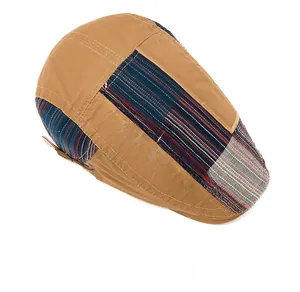 Detailed top view of patchwork newsboy cap with brown fabric and white zigzag stitching