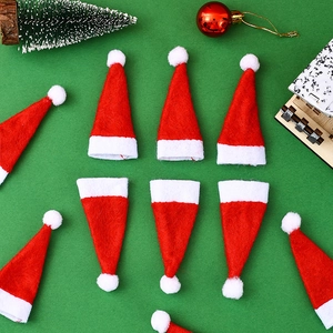 Macro shot of mini red Christmas hats for silverware holders and bottle decor
