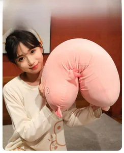 Pink U-shaped animal plush pillow showing high-density filling and soft plush texture