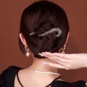 Detail of elegant silver S-curve hair clip with sparkling black and grey rhinestones