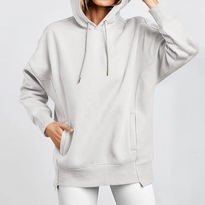 Detailed shot of oversized light grey hoodie with drawstring hood and front pocket