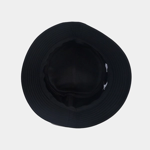Detailed top view of a black Halloween bucket hat showing the inner lining and white tag