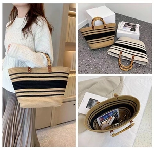 Detail of woven tote bag with bamboo handles and striped pattern showing spacious interior