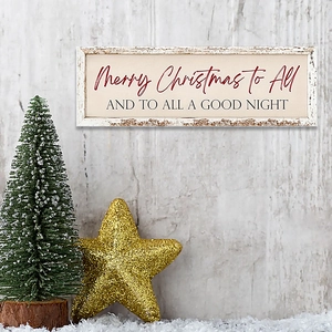 Wooden Merry Christmas sign hanging on wood wall with mini tree and golden star