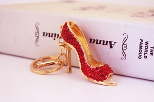 Close-up of red rhinestone high heel keychain with gold metal plating and lobster clasp