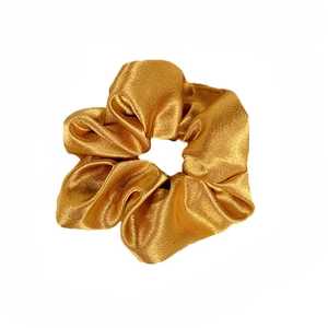 Glossy golden satin oversized scrunchie hair tie with elegant pleated silk texture