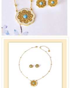 Detail of vintage gold flower necklace and earrings set with turquoise stones and zircons