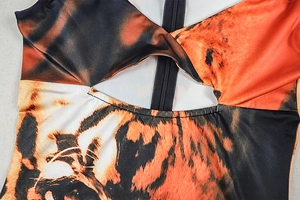 Detailed close-up of tiger print fabric with cutout knot design and functional zipper