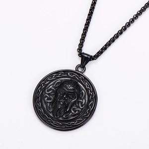 Macro view of Viking pendant necklace with bearded face and Celtic knot engraving