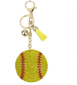 Close-up of a sparkling baseball keychain with yellow rhinestones and a gold tassel