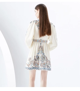 Detailed back view of a white mini dress featuring lantern sleeves and ethnic paisley prints