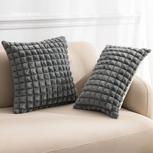 Faux rabbit fur pillow covers with 3D plaid pattern on a beige sofa in grey