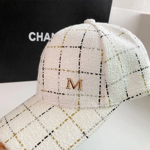White tweed baseball cap with gold M logo in an elegant tweed texture and luxury style