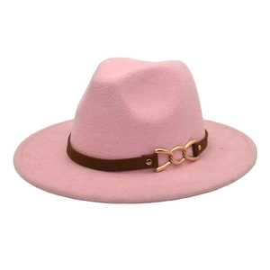 Detailed close-up of pink wool fedora hat with a brown leather strap and gold metal buckle