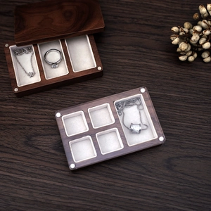 Detailed interior of walnut jewelry box with soft beige flocking lining and multi-slots